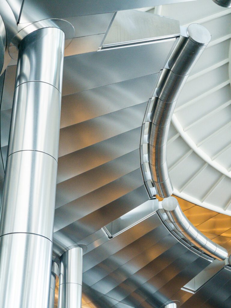 Contemporary interior featuring sleek stainless steel columns and abstract design details.